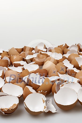 Pile of many broken brown empty eggshells