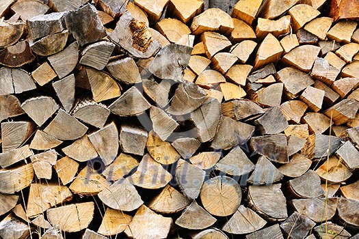 Background of chopped and split firewood logs stacked Background of chopped and split firewood logs stacked