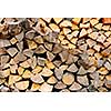 Background of chopped and split firewood logs stacked