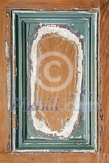 Old distressed wood door panel with peeling paint as framed background Old distressed wood door panel with peeling paint as framed background