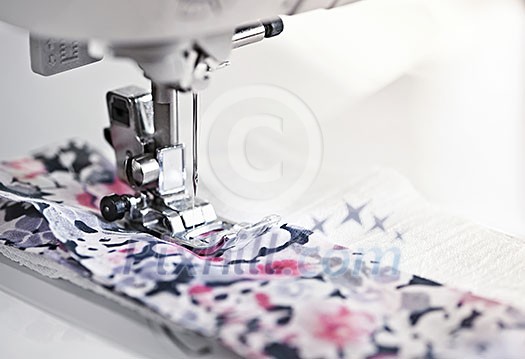 Closeup of sewing machine needle and thread with fabric Closeup of sewing machine needle and thread with fabric
