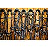 Leather horse bridles and bits hanging on wall of stable