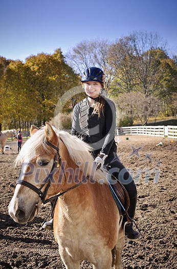 Portrait of teenage girl riding horse outdoors on sunny autumn day Portrait of teenage girl riding horse outdoors on sunny autumn day