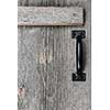 Distressed rustic barn wood door with handle as textured background