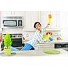 Smiling young black woman dancing and enjoying cleaning kitchen