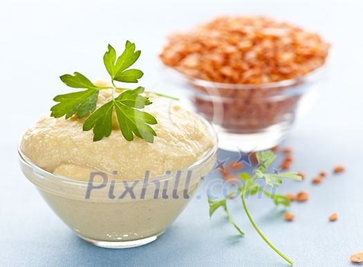 Red lentils and lentil hummus in bowls Red lentils and lentil hummus in bowls