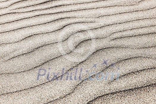 Natural background of sand in ripple wave pattern Natural background of sand in ripple wave pattern