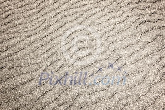 Natural background of sand in ripple wave pattern Natural background of sand in ripple wave pattern