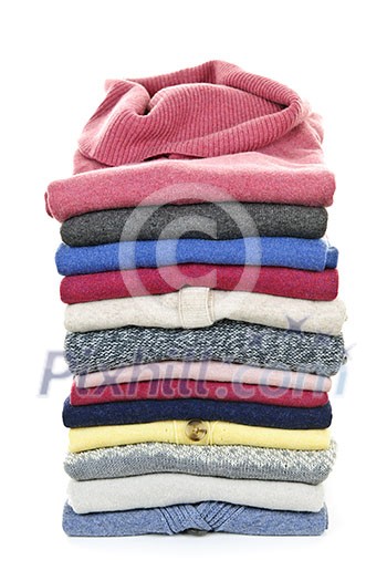 Stack of warm sweaters isolated on white background Stack of warm sweaters isolated on white background