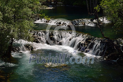 waterfall with clean and fresh water nature with green forest in background waterfall with clean and fresh water nature with green forest in background