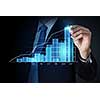 Close view of businessman drawing on screen market infographs