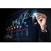 Close view of businessman drawing on screen market infographs