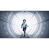 Young businessman running in futuristically designed tunnel