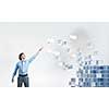 Businessman reaching hand to touch digital cube figure