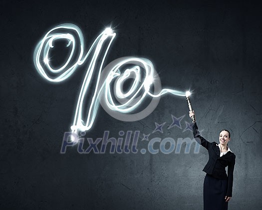 Businesswoman in darkness drawing percentage sign with flashlight Businesswoman in darkness drawing percentage sign with flashlight