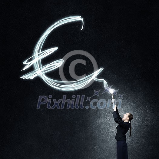 Businesswoman in darkness drawing euro sign with flashlight Businesswoman in darkness drawing euro sign with flashlight