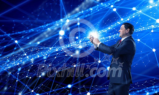 Businessman using his smartphone on background of connection lines Businessman using his smartphone on background of connection lines