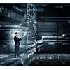 Businessman on digital futuristic background using his tablet pc