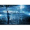 Businessman on digital futuristic background using his tablet pc