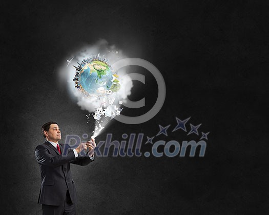 Businessman using his smartphone and Earth planet out of screen. Elements of this image are furnished by NASA Businessman using his smartphone and Earth planet out of screen. Elements of this image are furnished by NASA