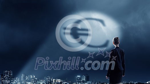 Businesswoman standing with back in darkness and euro sign in spothlight Businesswoman standing with back in darkness and euro sign in spothlight