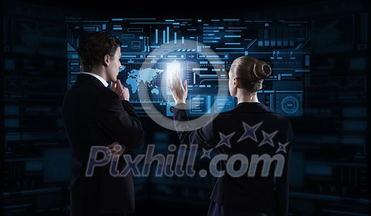 Rear view of businessman and businesswoman working with virtual panel interface Rear view of businessman and businesswoman working with virtual panel interface