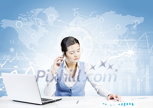 Beautiful young lady at desk talking on mobile phone with social network concept at background Beautiful young lady at desk talking on mobile phone with social network concept at background