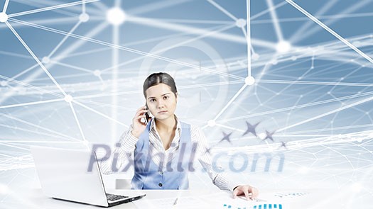 Beautiful young lady at desk talking on mobile phone with social network concept at background Beautiful young lady at desk talking on mobile phone with social network concept at background