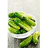 Fresh green pickling cucumbers in a glass bowl