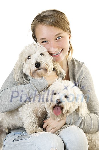 Pretty teenage girl holding two adorable coton de tulear dogs Pretty teenage girl holding two adorable coton de tulear dogs