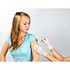 Teenage girl getting flu shot needle vaccination in arm