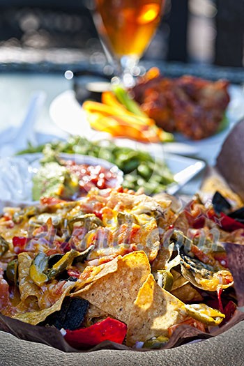 Basket of nachos and other appetizers on restaurant table Basket of nachos and other appetizers on restaurant table