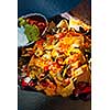 Basket of nachos with cheese jalapeno and toppings