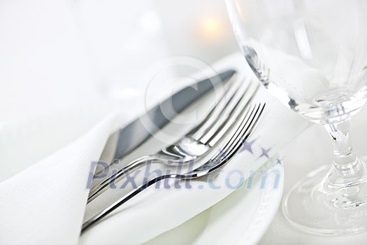 Elegant restaurant table setting for fine dining with plates cutlery and stemware Elegant restaurant table setting for fine dining with plates cutlery and stemware