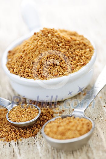 Organic coconut palm sugar in measuring spoons Organic coconut palm sugar in measuring spoons