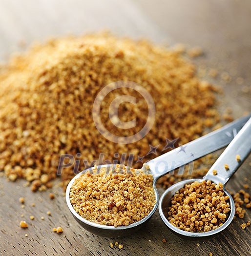 Organic coconut palm sugar in measuring spoons Organic coconut palm sugar in measuring spoons