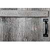 Distressed rustic barn wood door with handle as textured background