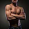 Muscular naked man on black