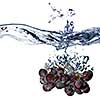 blue grape dropped into water with splash isolated on white