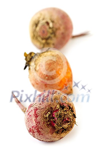 Close up of three whole red and golden beets isolated on white Close up of three whole red and golden beets isolated on white
