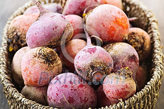Close up on basket of many whole red and golden beets Close up on basket of many whole red and golden beets