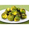 Plate of roasted green brussels sprouts on placemat