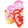 Homemade baked shortbread Valentine cookies and cupcakes with icing on white background