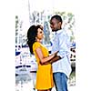 Young romantic couple facing each other hugging and standing at harbor