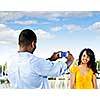 Beautiful woman posing for vacation photo at harbor with sailboats