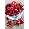 Dried cranberries spilling out of glass bowl