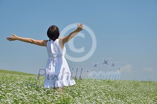 Young happy woman in green field with blue sky in background Young happy woman in green field with blue sky in background
