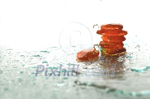 isolated wet zen stones with splashing water drops representing concept of natural balance and perfect harmony isolated wet zen stones with splashing water drops representing concept of natural balance and perfect harmony