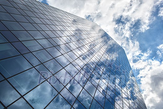 Modern building with reflection of blue sky and clouds