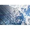 Modern building with reflection of blue sky and clouds